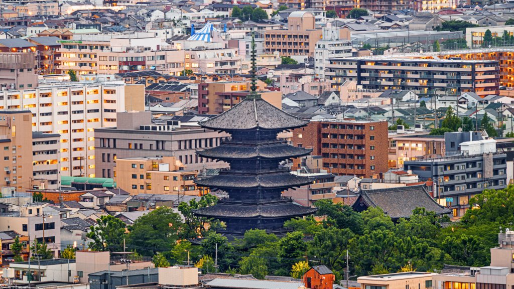 To-ji Pagoda, Kyoto’s tallest five-story pagoda, standing amidst the modern cityscape, blending ancient Japanese architecture with contemporary urban life.