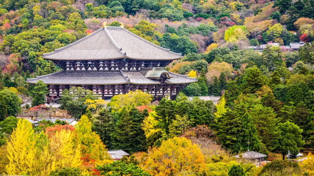 Tōdai-ji Temple in Nara, Japan, surrounded by vibrant autumn foliage, home to the Great Buddha and one of Japan’s most significant historical landmarks.