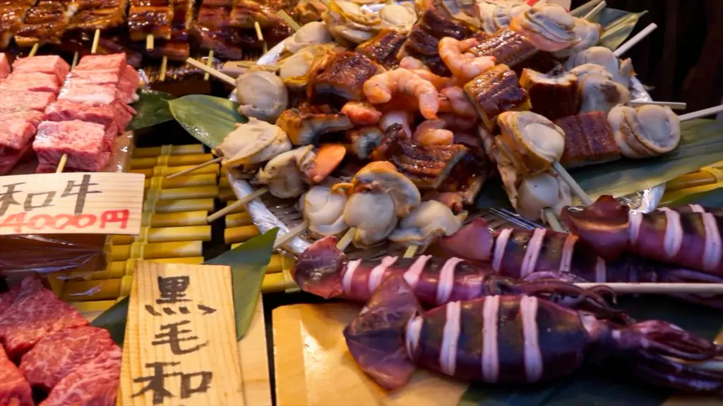 Fresh seafood and Wagyu beef skewers at Tsukiji Outer Market in Tokyo, Japan, featuring grilled eel, scallops, shrimp, and squid, a must-try street food experience.