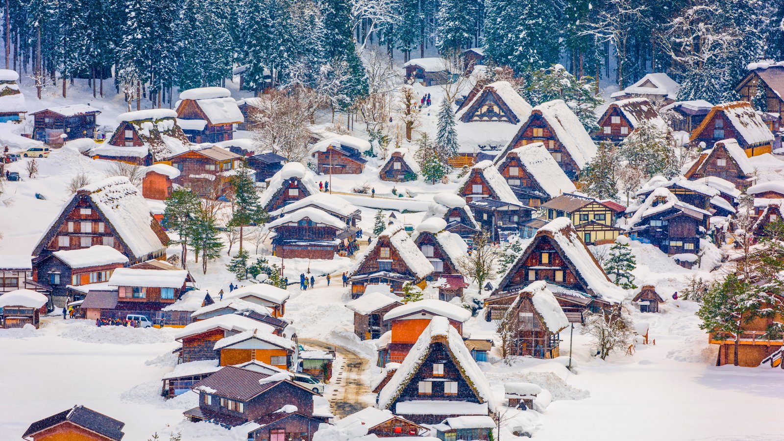 Shirakawa-go village in Japan covered in snow, showcasing traditional thatched-roof houses and a picturesque winter landscape in the Japanese Alps.